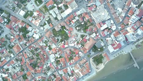 overhead drone shot revealing stunning larnaka cityscape, bricks houses roof, cyprus, europe