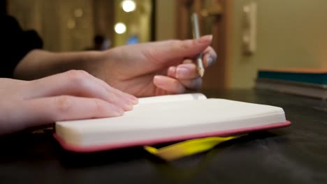 person writing in a notebook