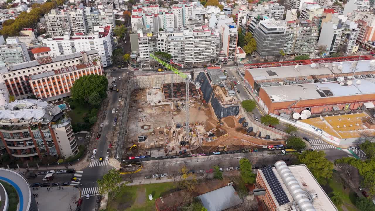 A construction site in buenos aires, showcasing machinery and buildings, aerial view