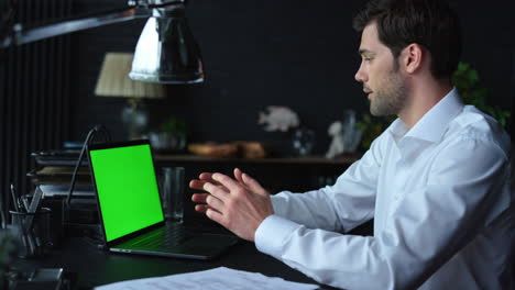 Businessman-video-calling-online-on-laptop-with-green-screen.-Man-using-laptop