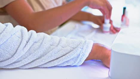 hands on woman at spa, nail polish