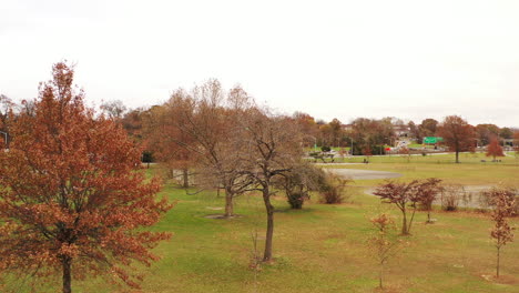 dolly in, low aerial drone shot, taken over the picnic area, on a cloudy day in flushing meadows corona park, ny