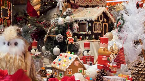 christmas decorations arrangement, christmas traditions with gingerbread houses, candies, toys, christmas tree and christmas lights.
