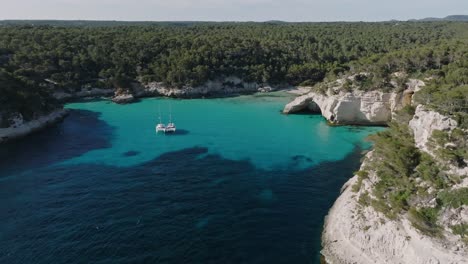 european summer destination with two yachts anchored spending the night isolated with the sea breeze through their sails