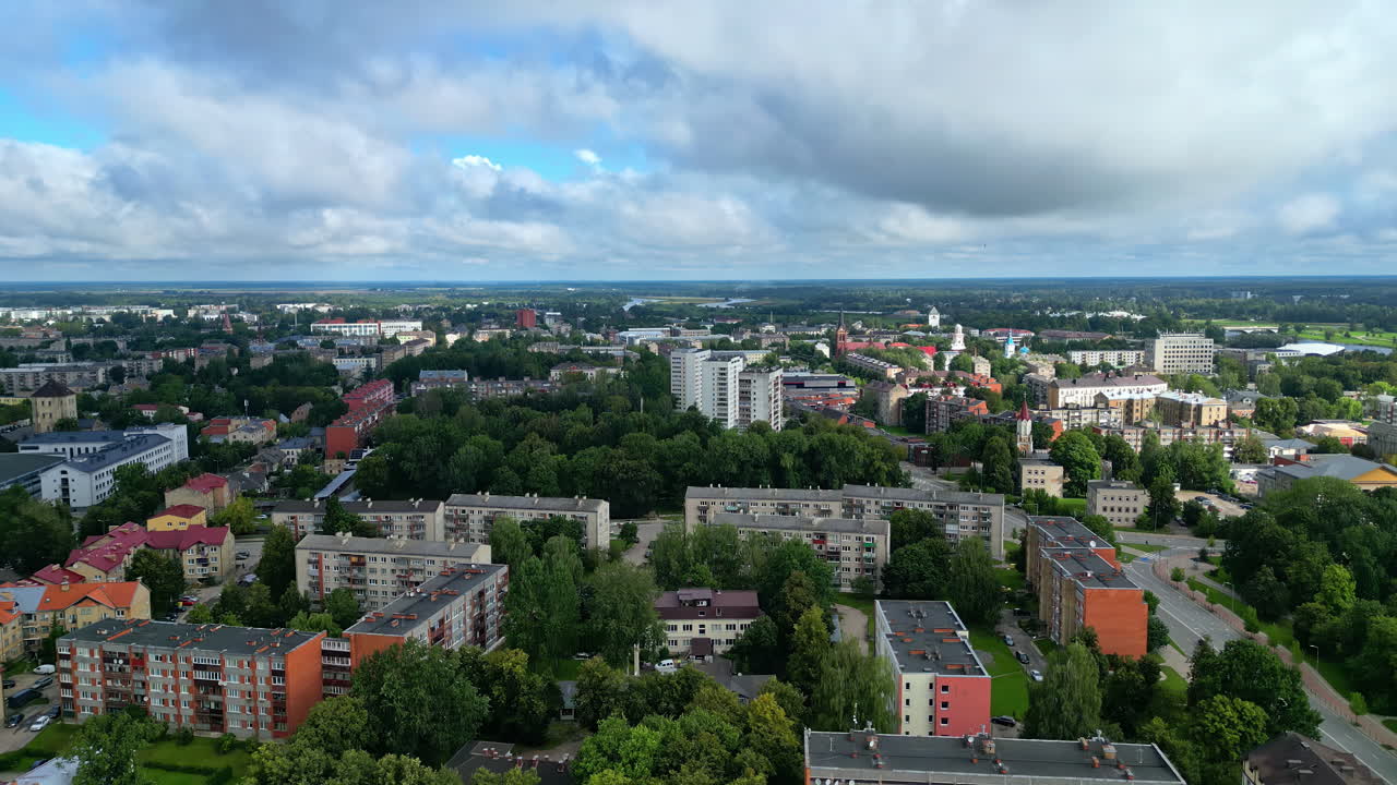 Elevating shot of urban landscape with residential buildings and tree-lined streets. Jelgava, Latvia