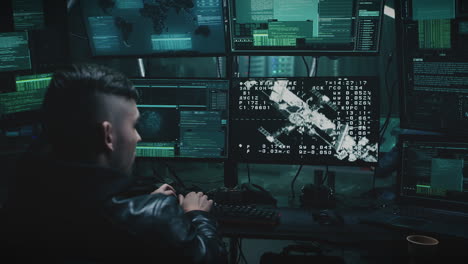 cybersecurity professional working in a dark control room with multiple monitors