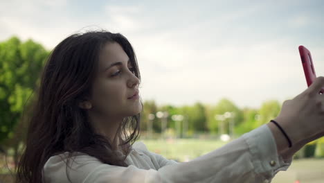 Joven-Italiana-Con-Smartphone-Tomando-Selfie-Al-Aire-Libre-En-Un-Parque-En-Londres