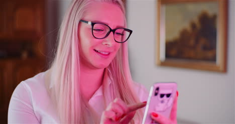 smiling businesswoman using mobile phone in office