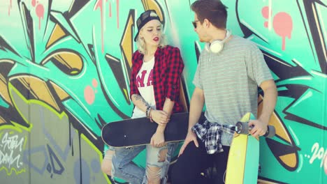 Trendy-modern-urban-couple-chatting-at-skate-park