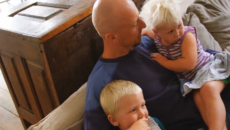 father and children relaxing on sofa 4k