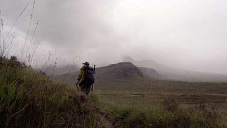 walking along a hiking trail in the scottish mountains and exiting frame around a corner