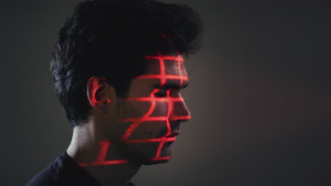 facial recognition technology concept as man has red grid projected onto eye in studio