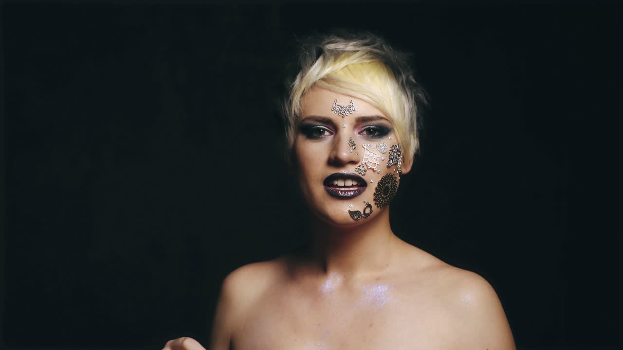 Woman holds her fingers in the heart. Cute woman holds her fingers in the heart on a black background