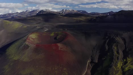 scenery of red volcanic craters in raudaskal, southern iceland, panning drone shot