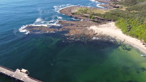 drone pan shot of coal loading bridge wharf with ocean waves at catherine hill bay moonee beach lake macquarie swansea nsw australia 3840x2160 4k