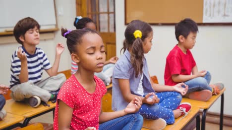 Animation-of-schoolchildren-sitting-meditating-in-school-classroom