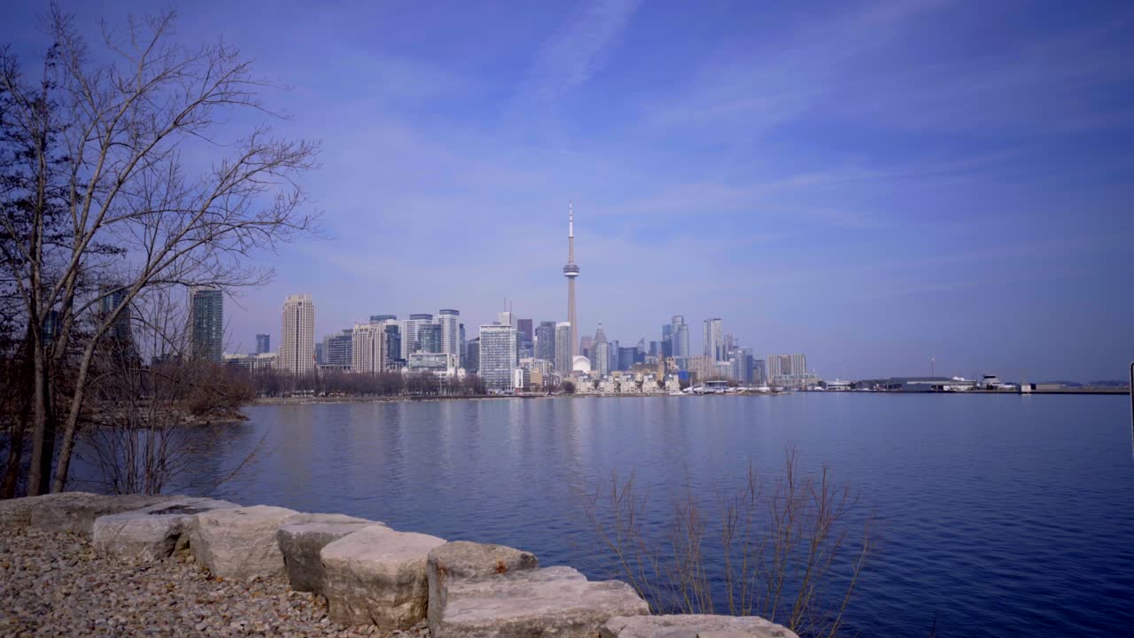 Beautiful landscape establishing shot of Toronto, Ontario, Canada skyline from Trillium Park, Ontario provincial park developed along Lake Ontario noon