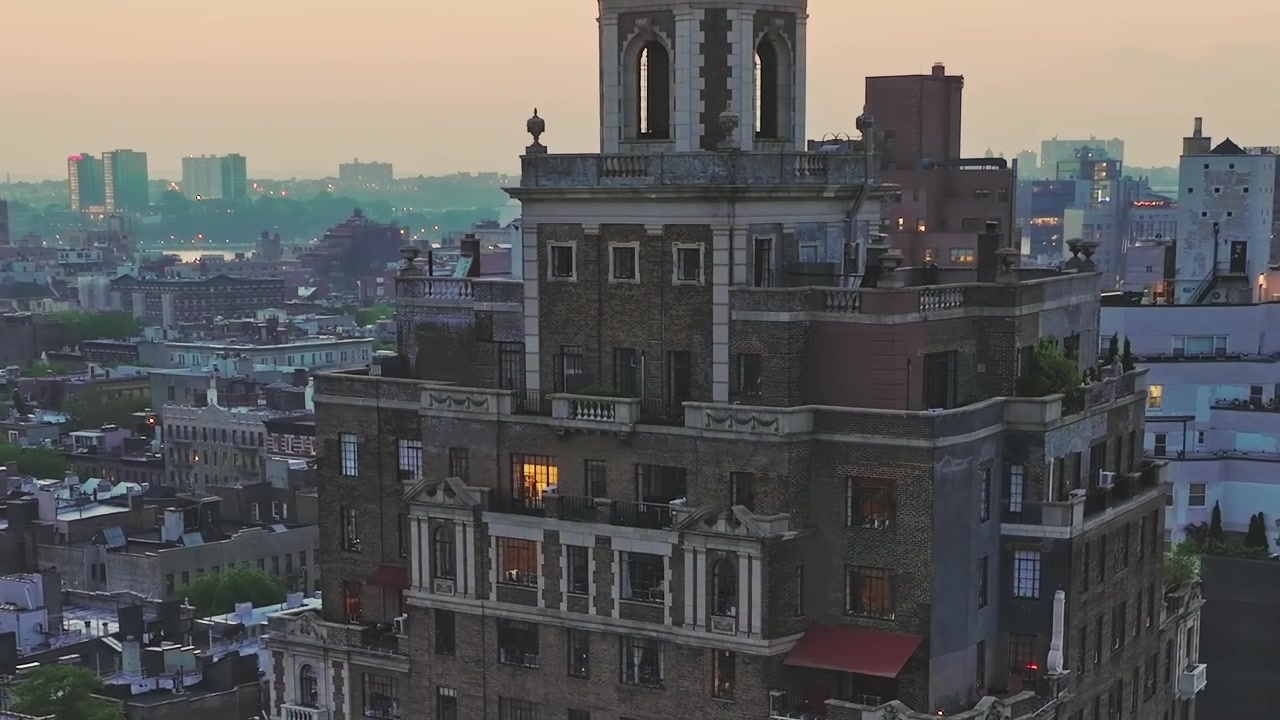 Vista di un vecchio edificio a New York City al tramonto con le luci accese