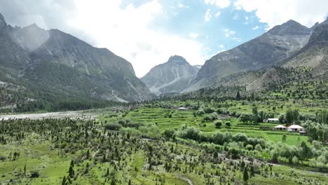 aerial establishing shot of basho valley in skardu on clear day with mountains in background