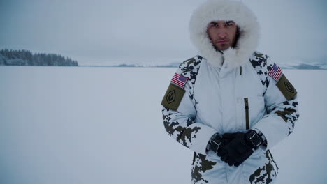 man in winter camouflage clothing in snowy landscape