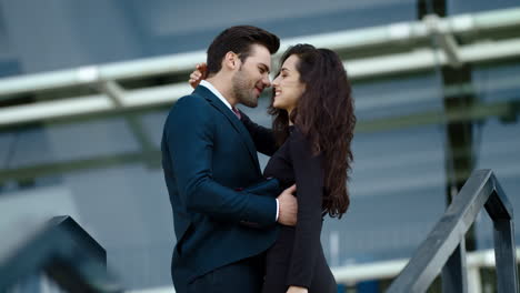 Close-up-young-couple-meeting-at-street.-Business-man-and-woman-smiling-outdoors