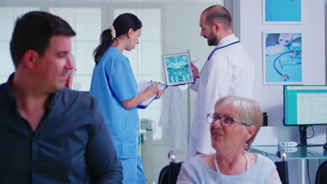 Doctor-checking-radiography-on-nurse-digital-tablet