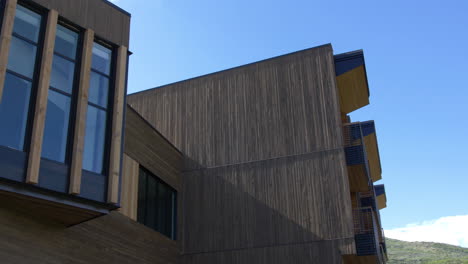 modern building with dark wood paneling and large windows