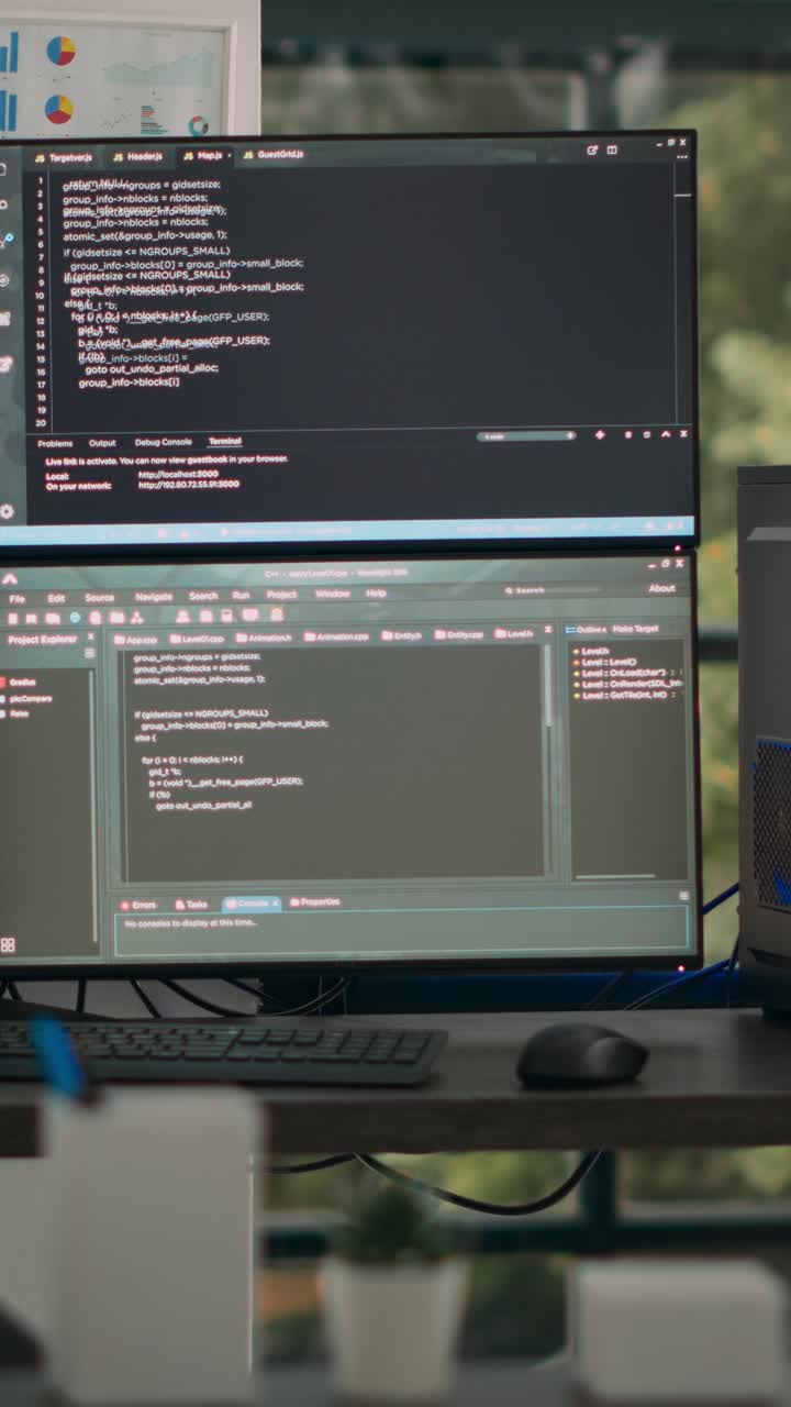 Vertical video: Multiple screens showing programming code in empty software it agency desk