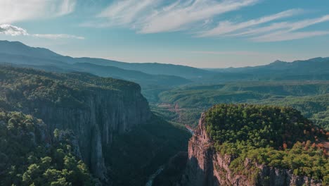 aerial view of a mountain valley with forest and canyon