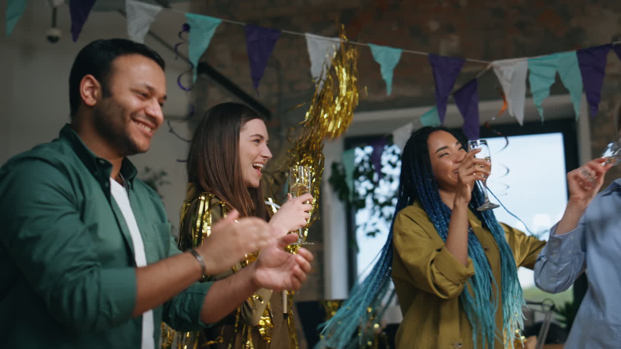 equipo emocionado disfrutando de celebrar el cumpleaños en la oficina decorada. compañeros de trabajo bailando