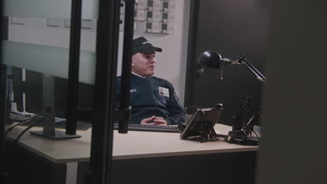 security guard working at his desk in a control room