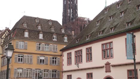 view of strasbourg cathedral towering above the alsace architecture at a festive christmas market in strasbourg, france europe