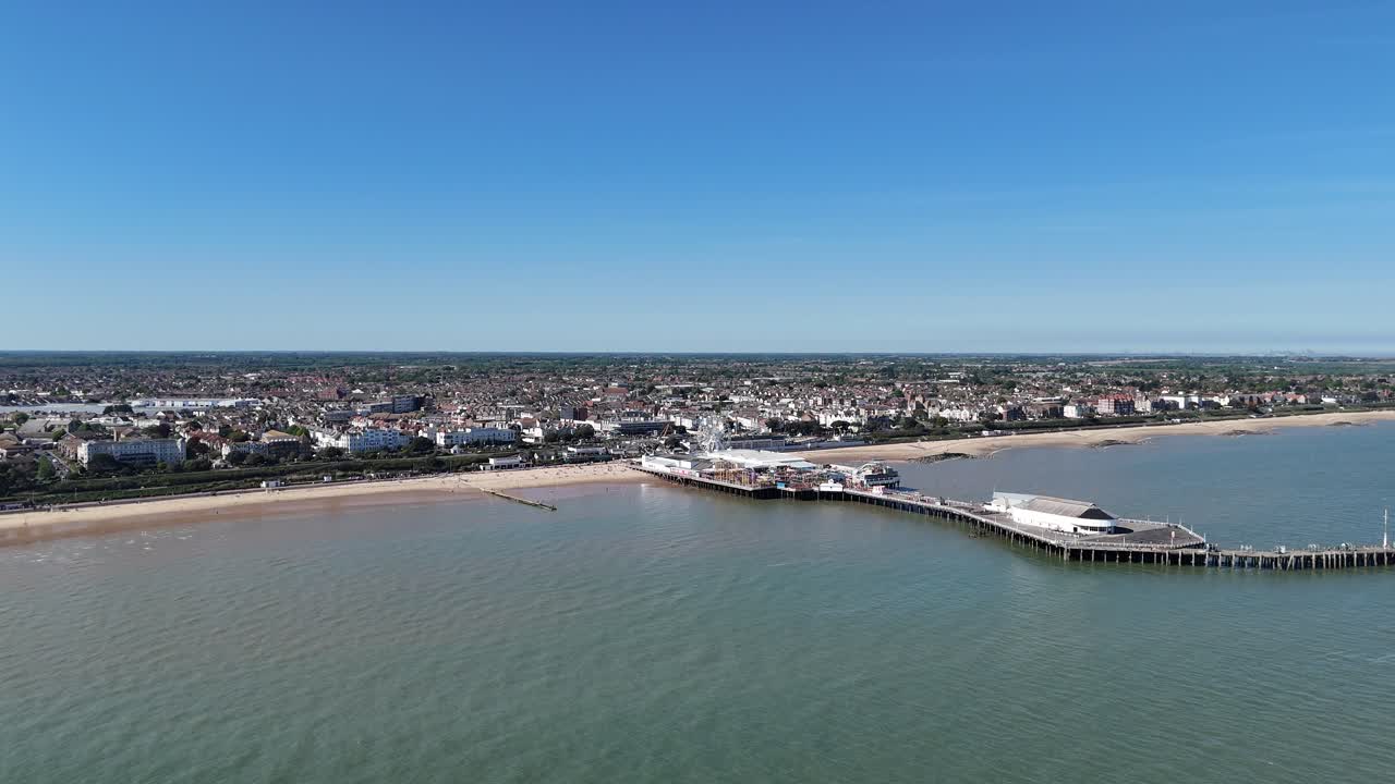 Establishing aerial shot Clacton On Sea Essex beach and pier day clear blue sky