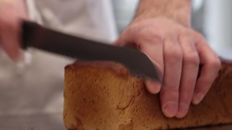 baker holding freshly baked bread loaf