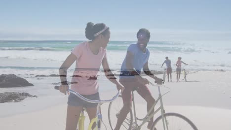 animation of happy african american couple with bikes over seascape