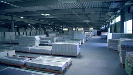 inside the large warehouse with stored materials. ready-made doors packed and piled ready for transportation.