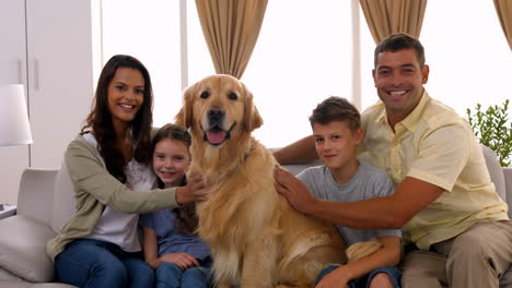 happy family smiling with their dog