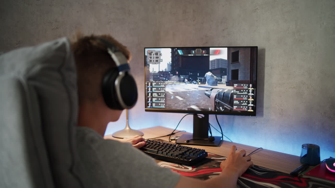 Teenage gamer playing a video game on a computer