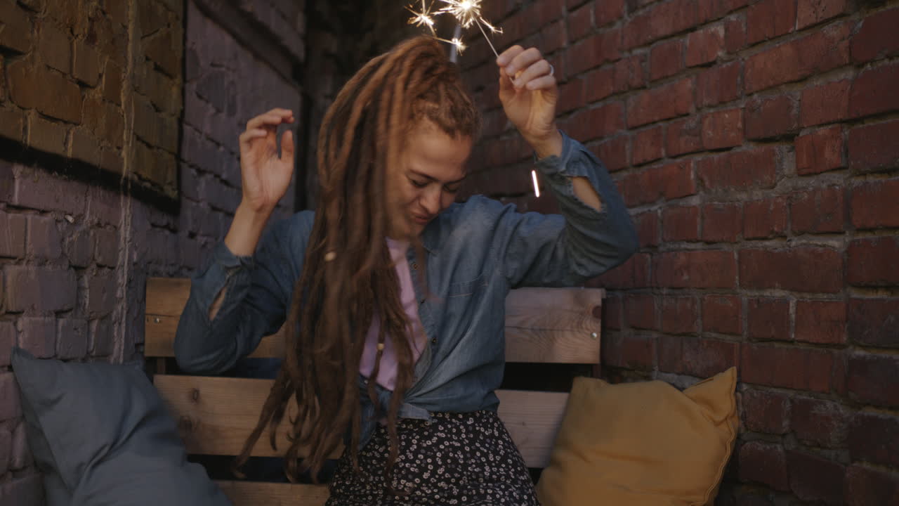 Woman with sparkler outdoors