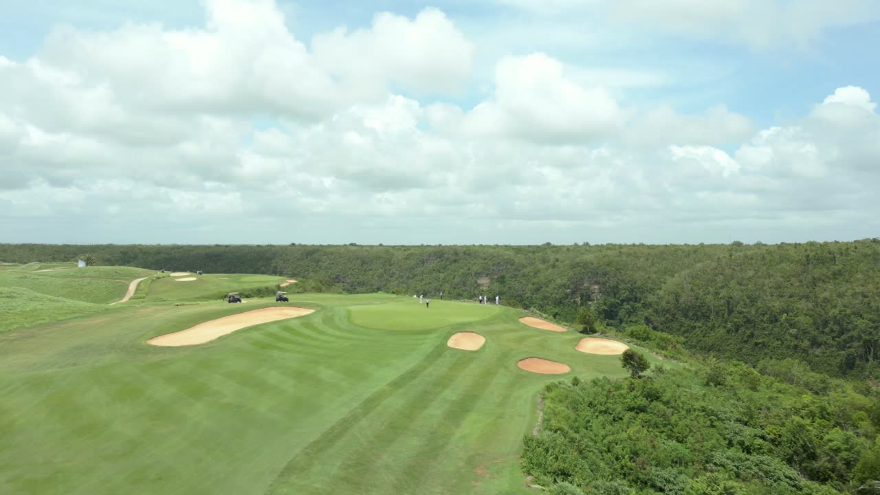 Aerial view flying over a caribbean golf course, sunny day in Dominican republic