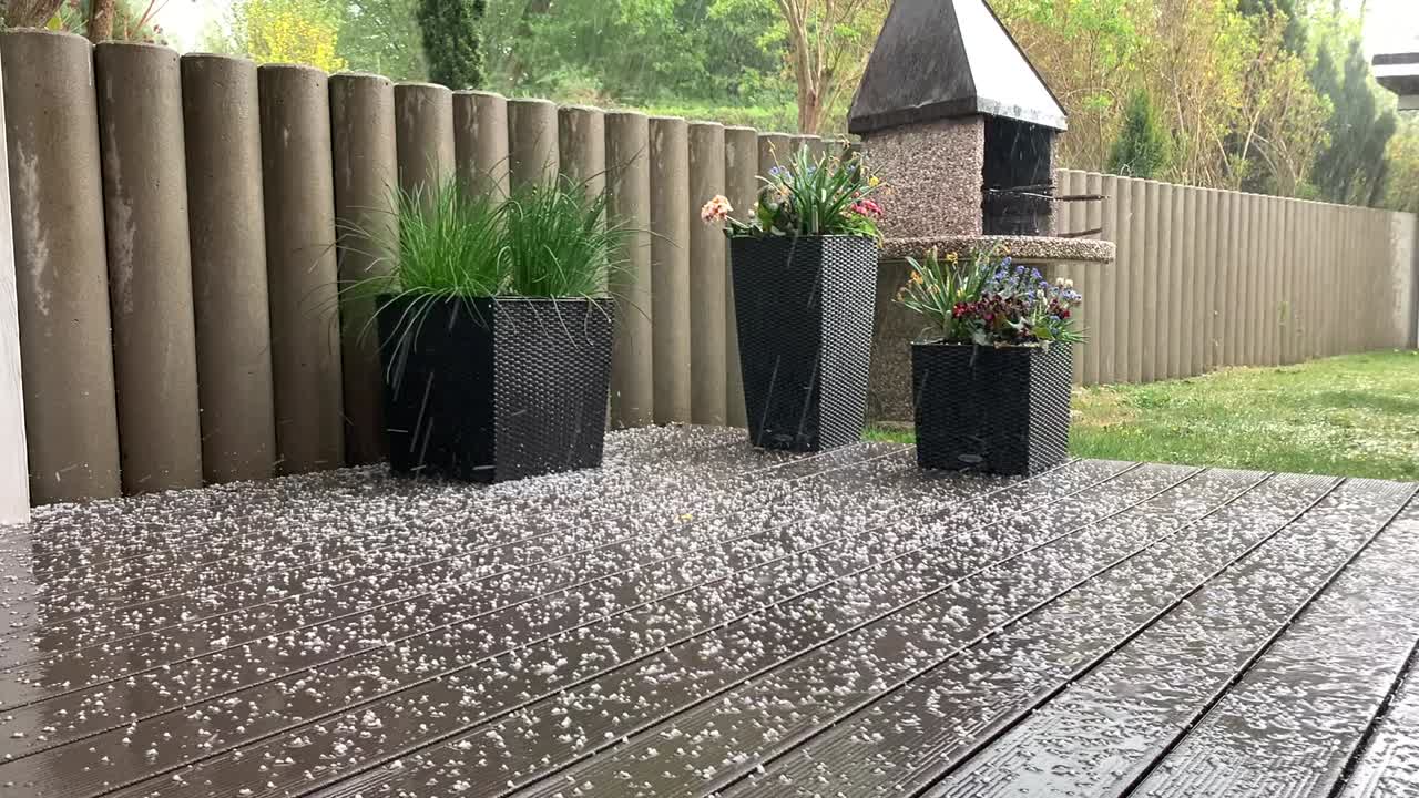 a hailstorm comes down in a garden