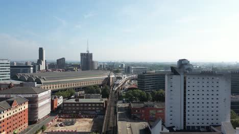 Aerial-drone-flight-over-the-train-tracks-from-Oxford-Road-to-Piccadilly-Train-Station-in-Manchester-City-Centre