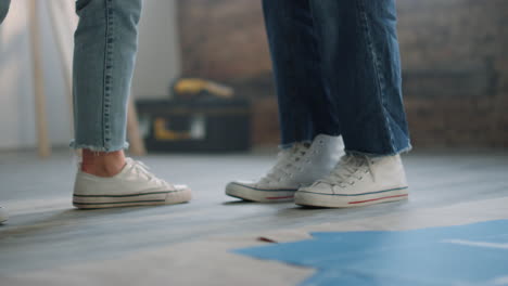 legs of happy couple making dance steps indoors. people feet dancing on floor.