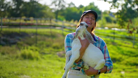 woman holding a baby goat