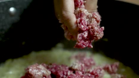 chef adding minced beef to the pot, crafting a rich and flavorful bolognese sauce in a bustling kitchen environment