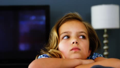 Thoughtful-girl-relaxing-on-sofa-in-living-room