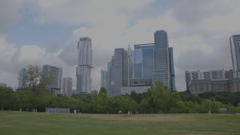 pan left to right on austin, texas skyline with people running and walking in distance