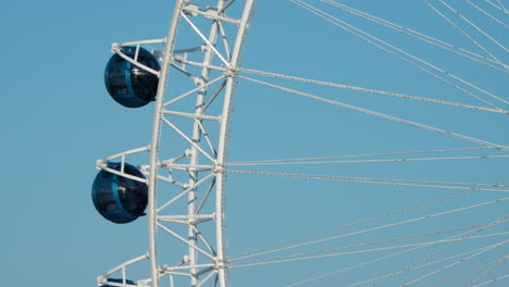 Ball-shaped-Rotating-Sokcho-Eye-Cabins-Close-up---Ferris-Wheel-Against-Blue-Sky-in-Sokcho-City,-South-Korea---Pods-Close-up-from-Distance