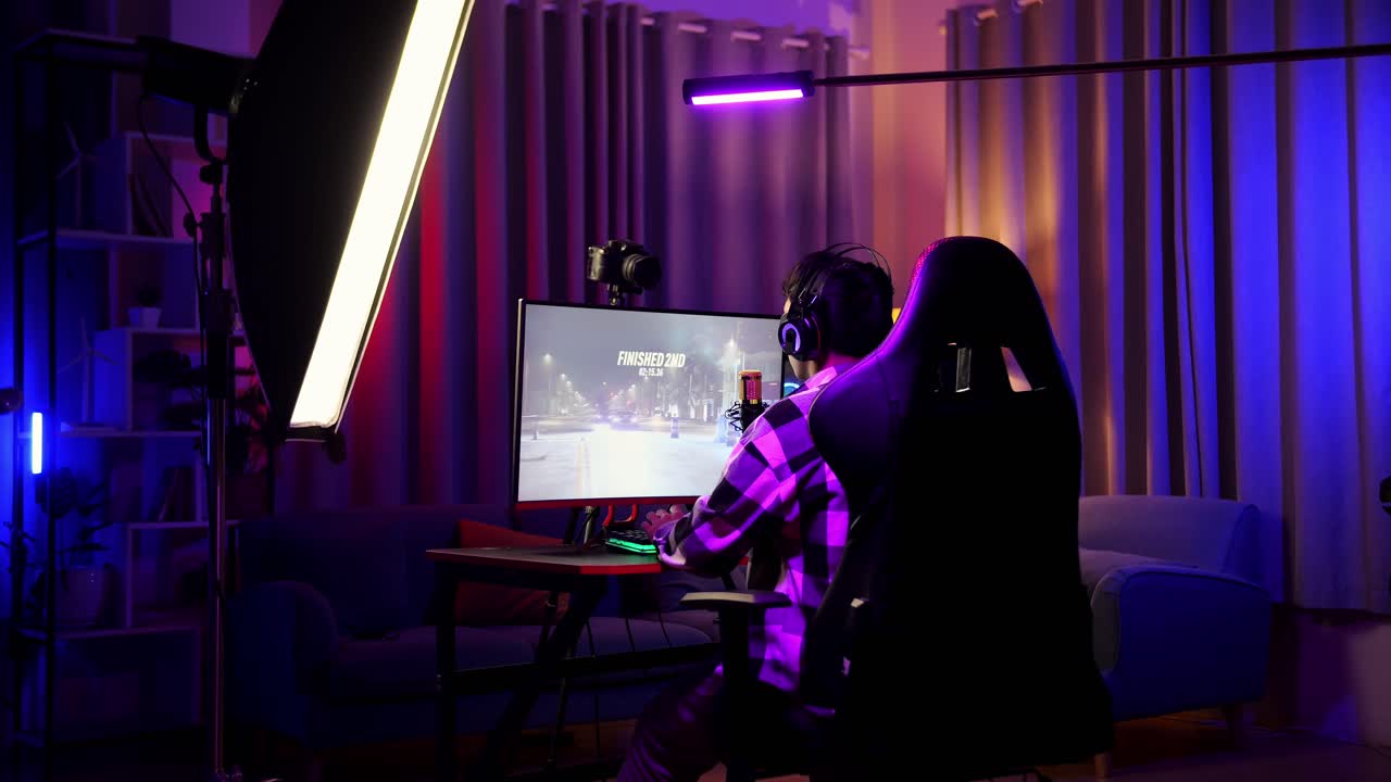 Back View Of Asian Boy Streamer Feeling Disappointed Fails Car Racing Game Over On Personal Computer.  Live Stream Video Game, Desk Illuminated By Rgb Led Strip Light