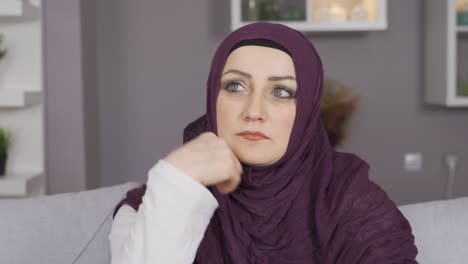 muslim woman in hijab is thoughtful.